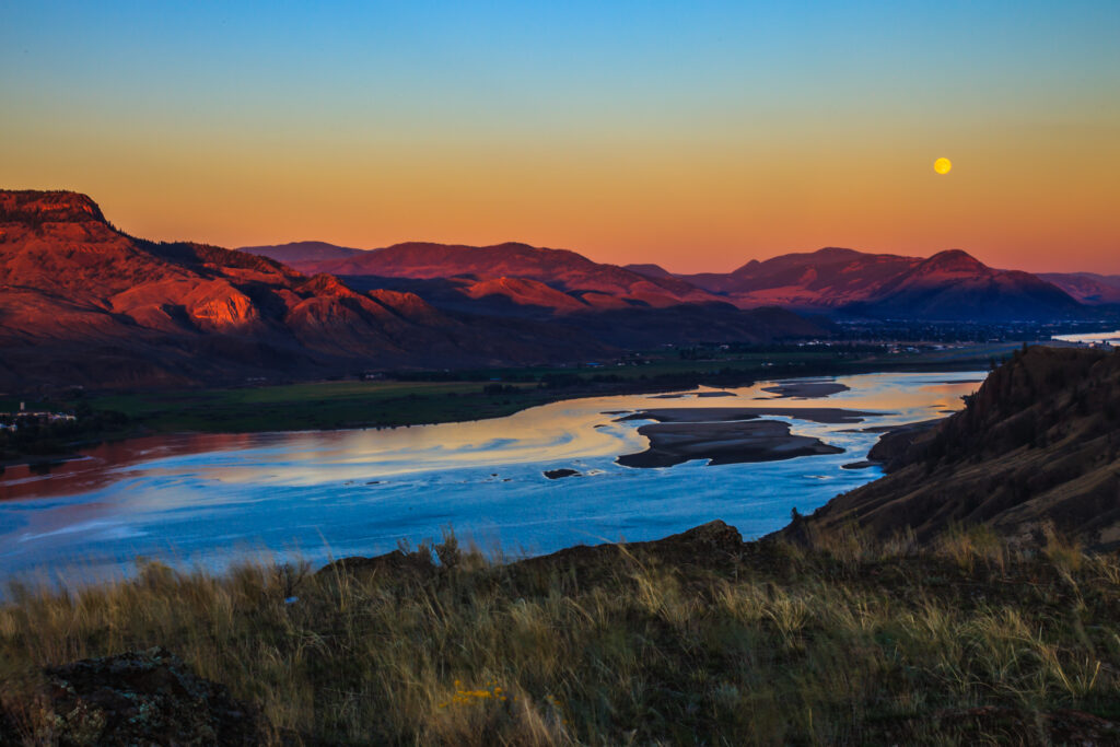 The image shows Kamloops city during a sunset